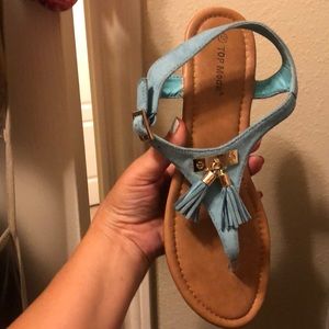 Turquoise sandals with hold tassel.
